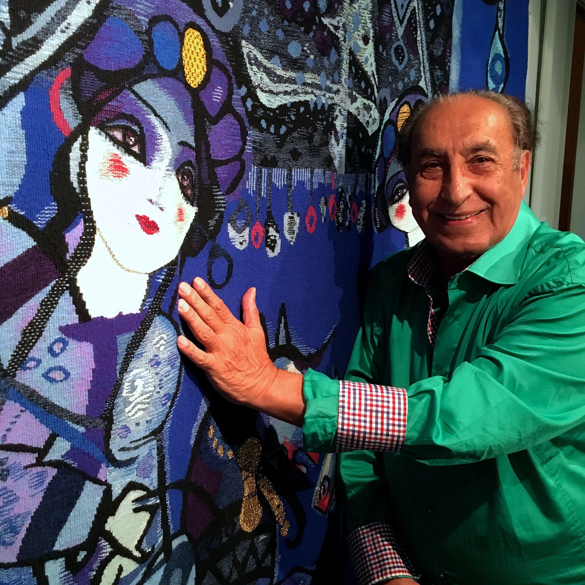 Nasser Ovissi and one of his tapestries.