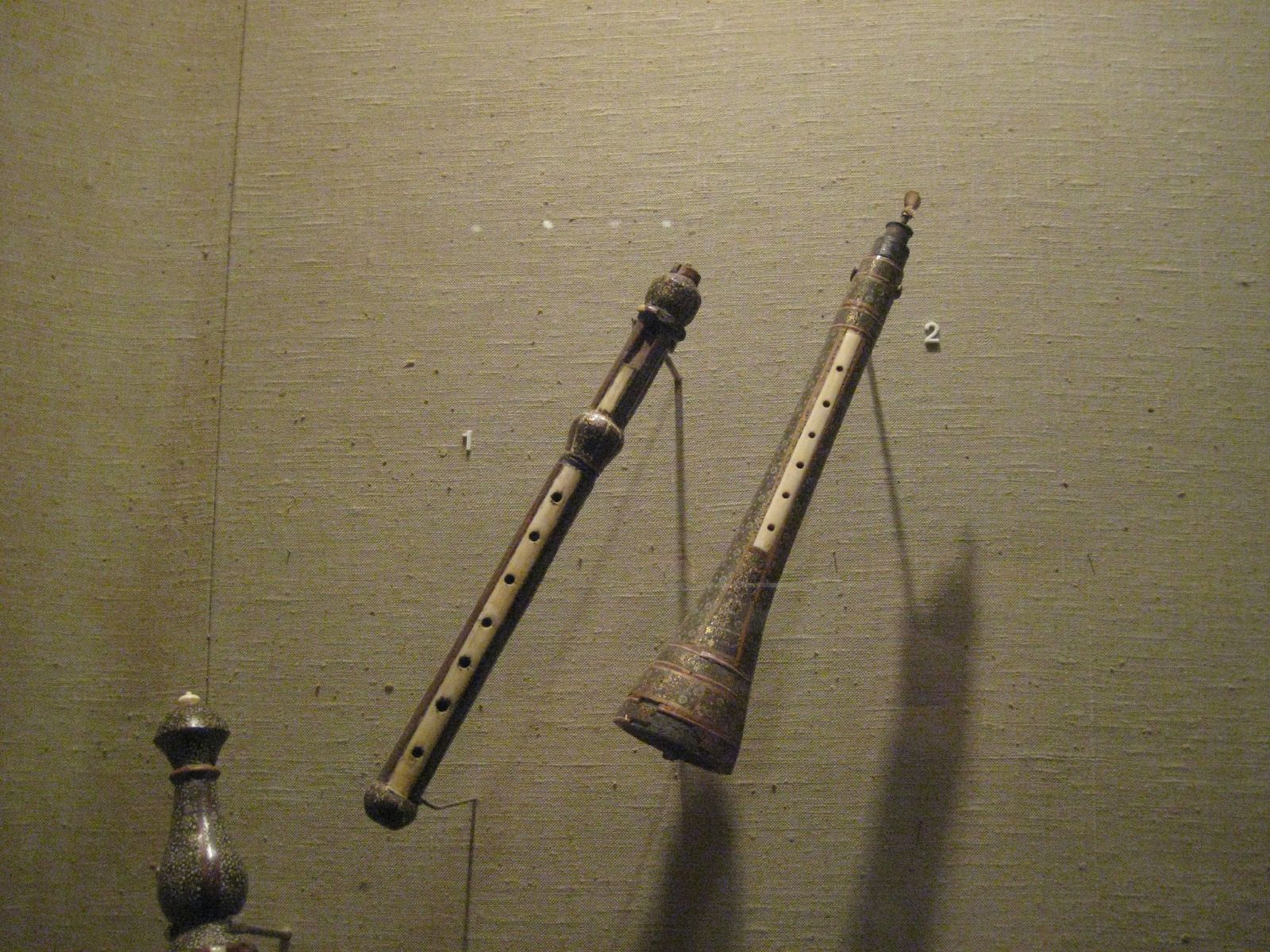 The label is very blurry, but I did my best... Left: Nay Inarm (?) or Soft Flute Item number: 89.4.27?? Nerme Ney Accession Number:89.4.2709 Geography: Iran Medium: wood, metal Dimensions: L. 33cm (13in.) Classification: Aerophone-Reed Vibrated Credit Line: The Crosby Brown Collection of Musical Instruments, 1889 Right: Sorna (Feast Flute?) Item number: 89.4.27?? Sorna Accession Number:89.4.2710 Date: late 19th century Geography: Iran Medium: wood, bone, metal Dimensions: L. 31.1cm (12 1/4in.) Classification: Aerophone-Reed Vibrated Credit Line: The Crosby Brown Collection of Musical Instruments, 1889 Both are bone, wood, bronze, and brass