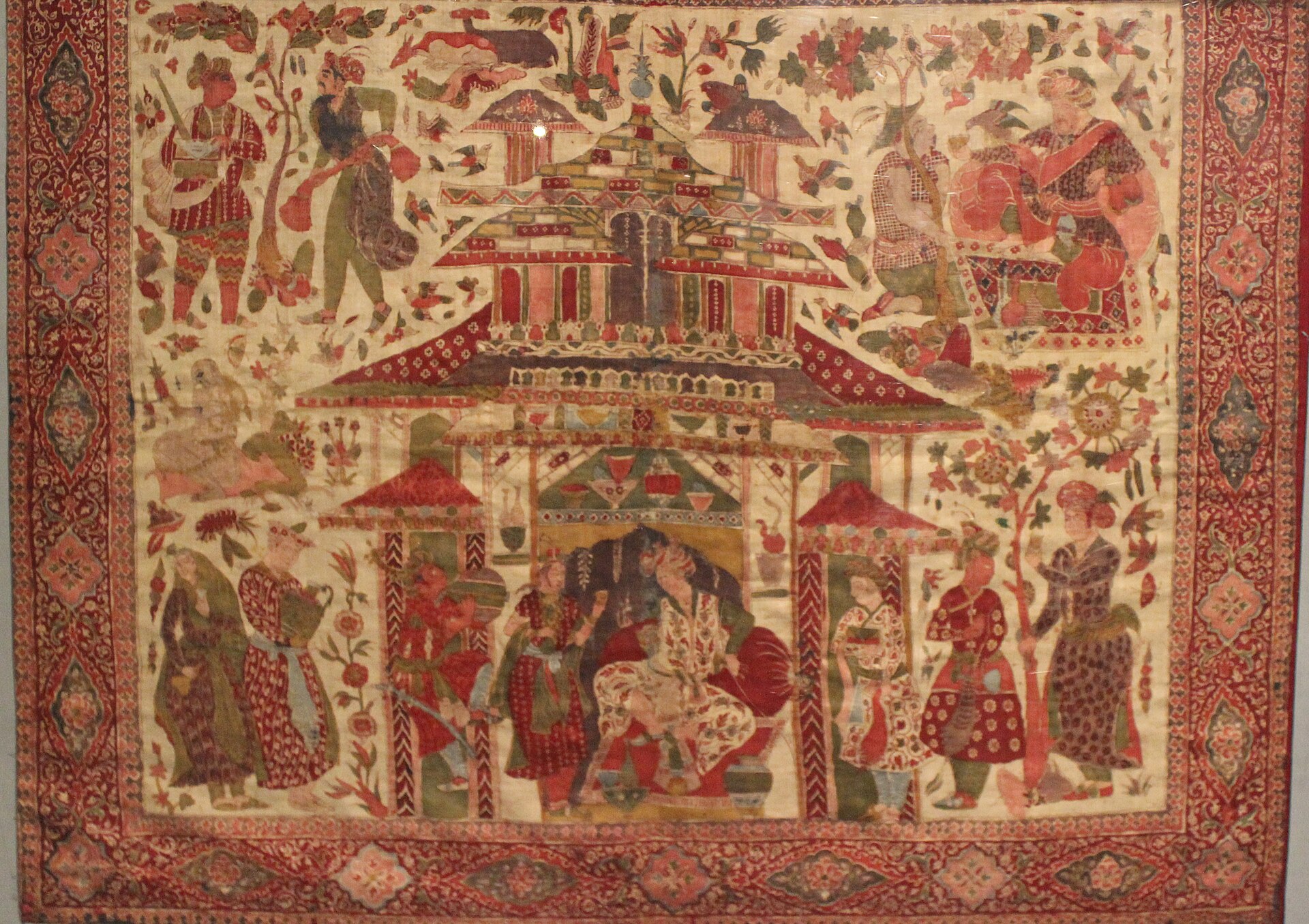 Golconda Region Cotton, drawn and painted resist and mordant size: 89x74cm this rare kalamkari shows the cosmopolitan world of the Deccan Sultanates. in an fanciful palace a ruler in Persian clothes accepts wine from a woman in a European hat, Armenians, Chinese, Turks and Iranians stage an appearance in the garden.