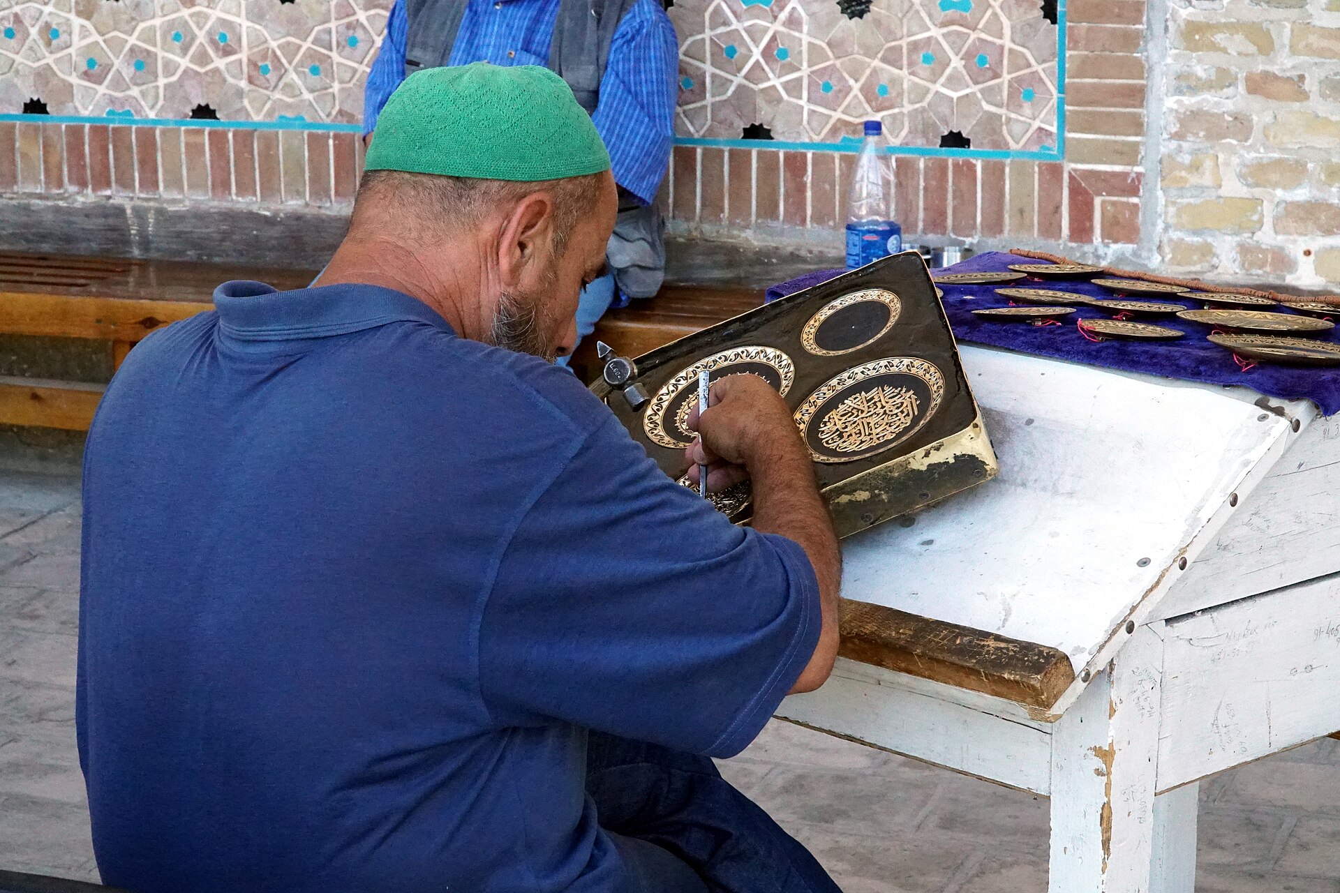 A craftsman engraving on a metal plate in Bukhara, Uzbekistan
