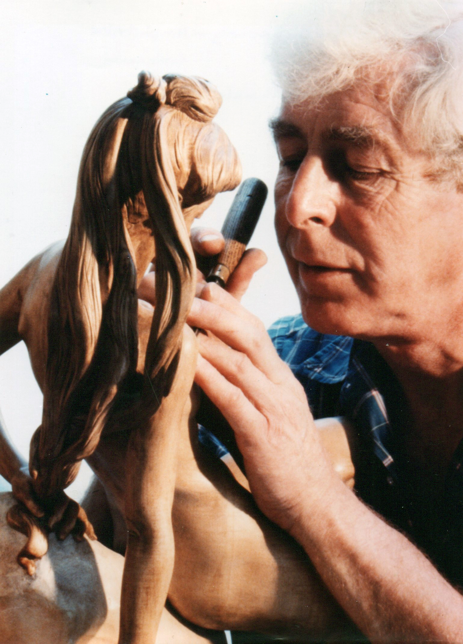 Denis Parsons ' interpretation of Amphitrite from Greek Mythology, carved in Lime wood, height 1'8". The various expressions expressed in the face was always important to Denis who gained a reputation for the graceful form of his figurative work. Parsons finishing the figure.