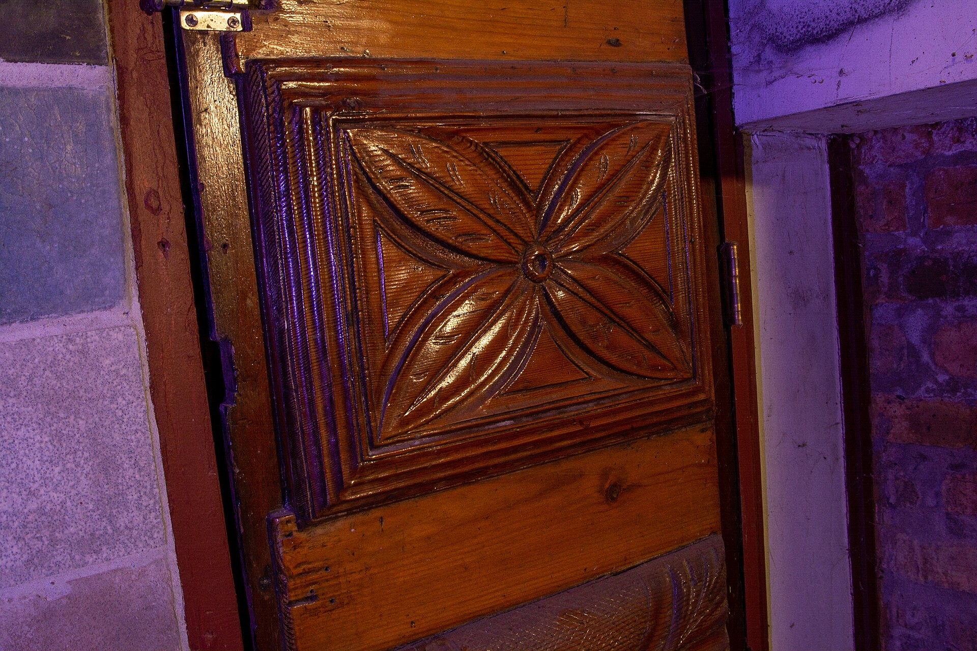 The top panel of a hand-carved wooden door at the Carl Street Studios, in Chicago, IL. The craftsmen on the Studios were Jesús Torres and Edgar Miller, with much of the woodcarving done by Torres
