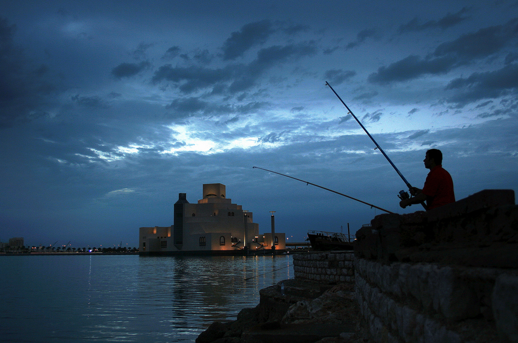 Fisherman on the Doha Corniche next to the Museum of Islamic Art, Qatar. The picture is entitled "Fisherman In Time" by Aju George Chris.